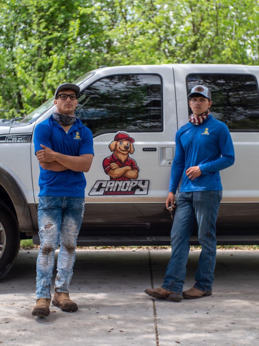 Canopy Land Solutions owners in front of a branded truck