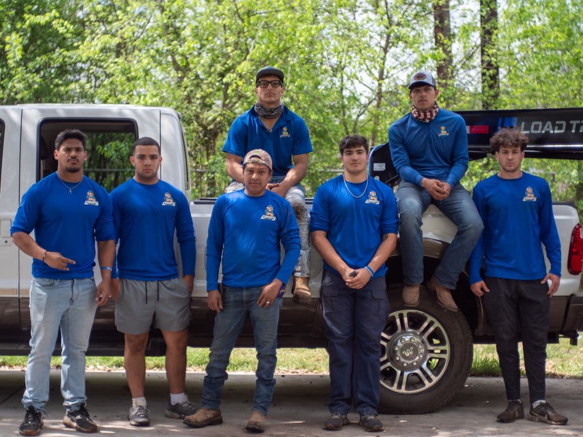 The Canopy Land Solutions crew — seven team members in branded blue shirts