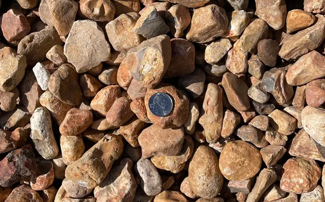 Orange River Rock — Rock & Gravel material delivered and installed by Canopy Land Solutions in San Antonio, TX